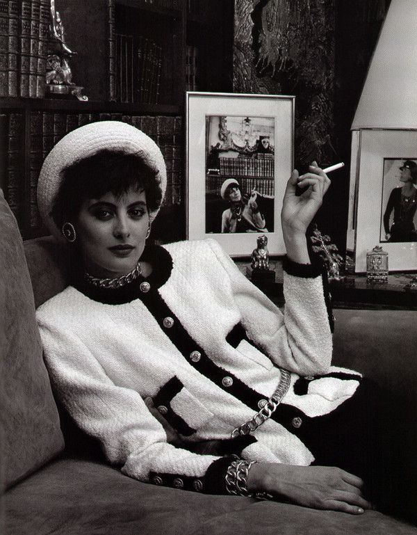 Ines De La Fressange in Chanel with photo of Coco Chanel c1964 in the  background