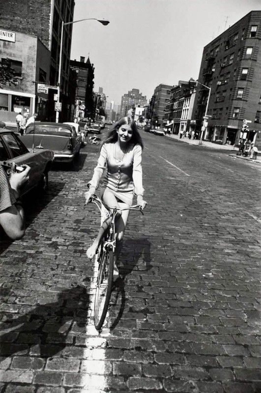 Garry Winogrand - Woman riding bicycle